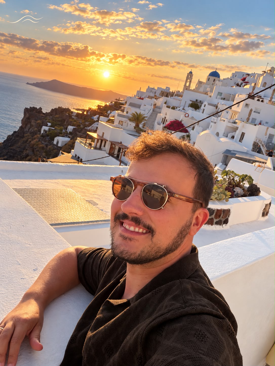 Pôr do sol dourado sobre as casas brancas de Oia, em Santorini